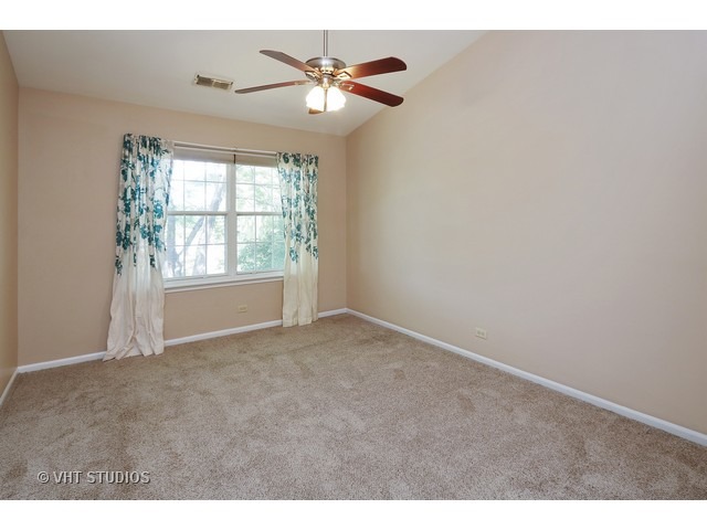 17814 Braewick Road, Unit 17814 Gurnee, IL 60031 - Photo 7 of 10 a view of an empty room with a window