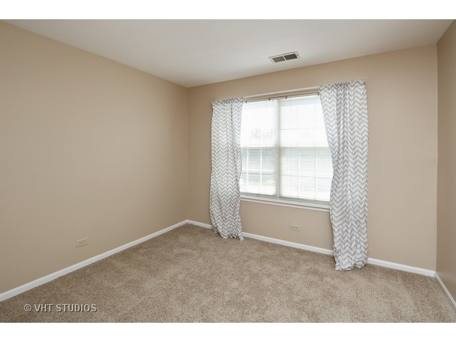 17814 Braewick Road, Unit 17814 Gurnee, IL 60031 - Photo 8 of 10 a view of an empty room with a window