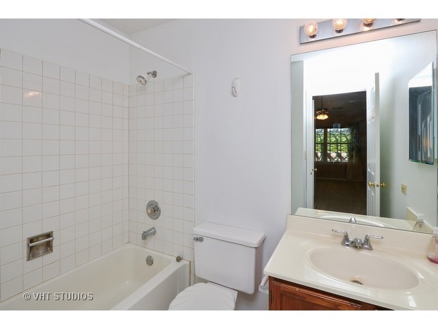17814 Braewick Road, Unit 17814 Gurnee, IL 60031 - Photo 9 of 10 a bathroom with a tub sink vanity and mirror