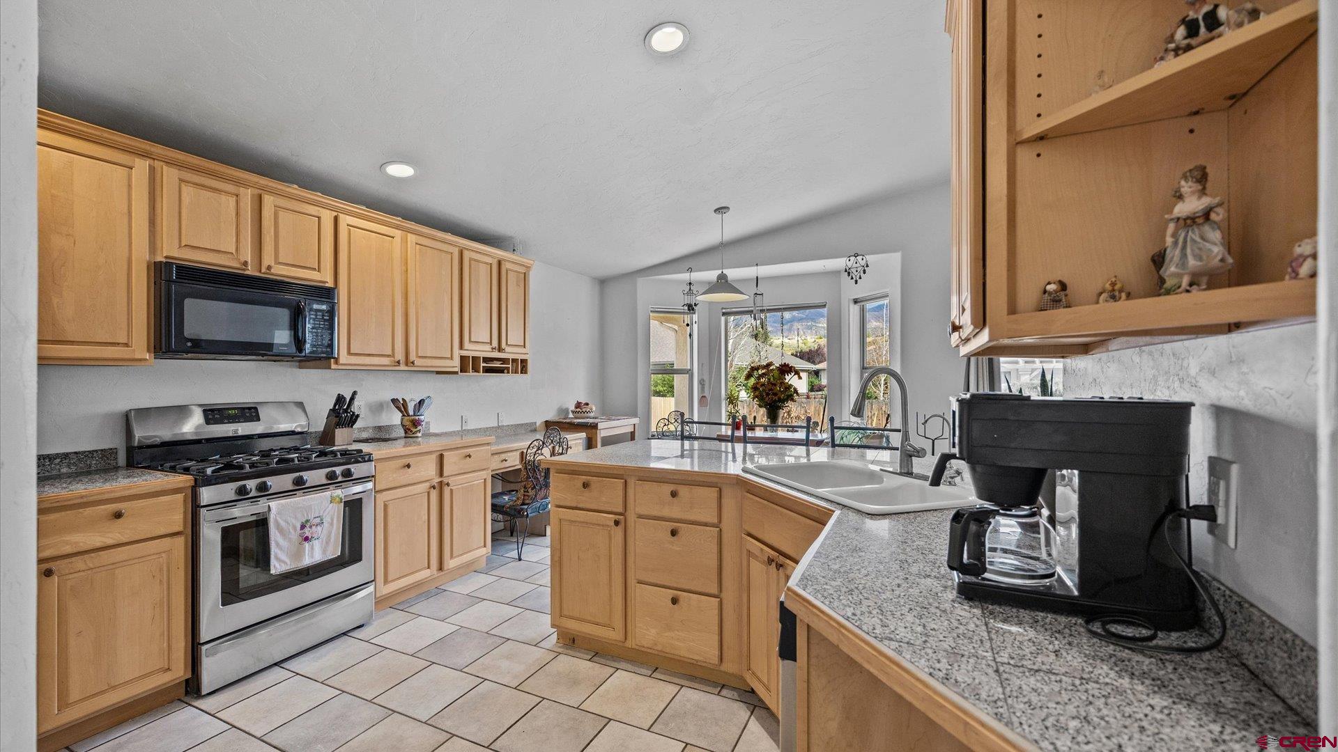 18 Willow Creek Court Parachute, CO 81635 - Photo 13 of 31 a kitchen with a stove top oven sink and cabinets