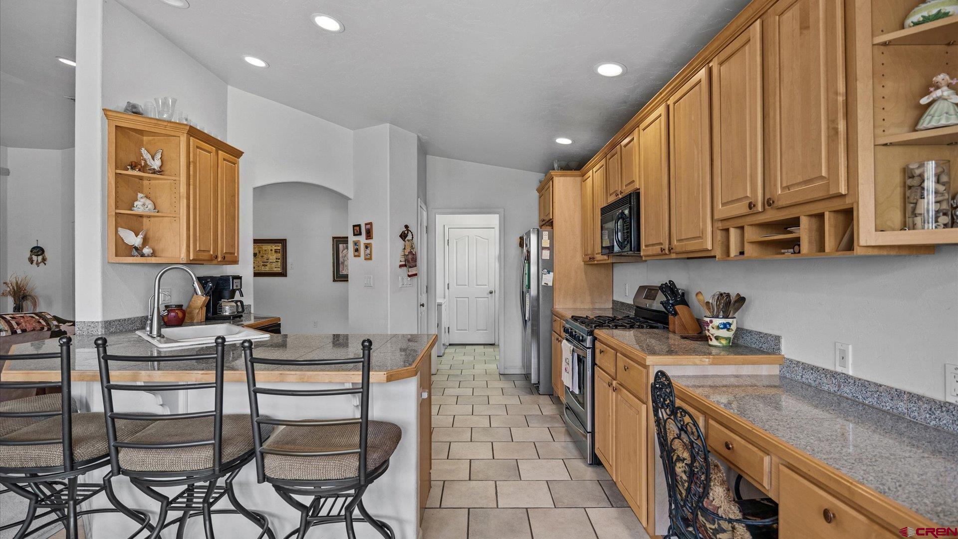 18 Willow Creek Court Parachute, CO 81635 - Photo 15 of 31 a kitchen with stainless steel appliances kitchen island granite countertop a sink and cabinets