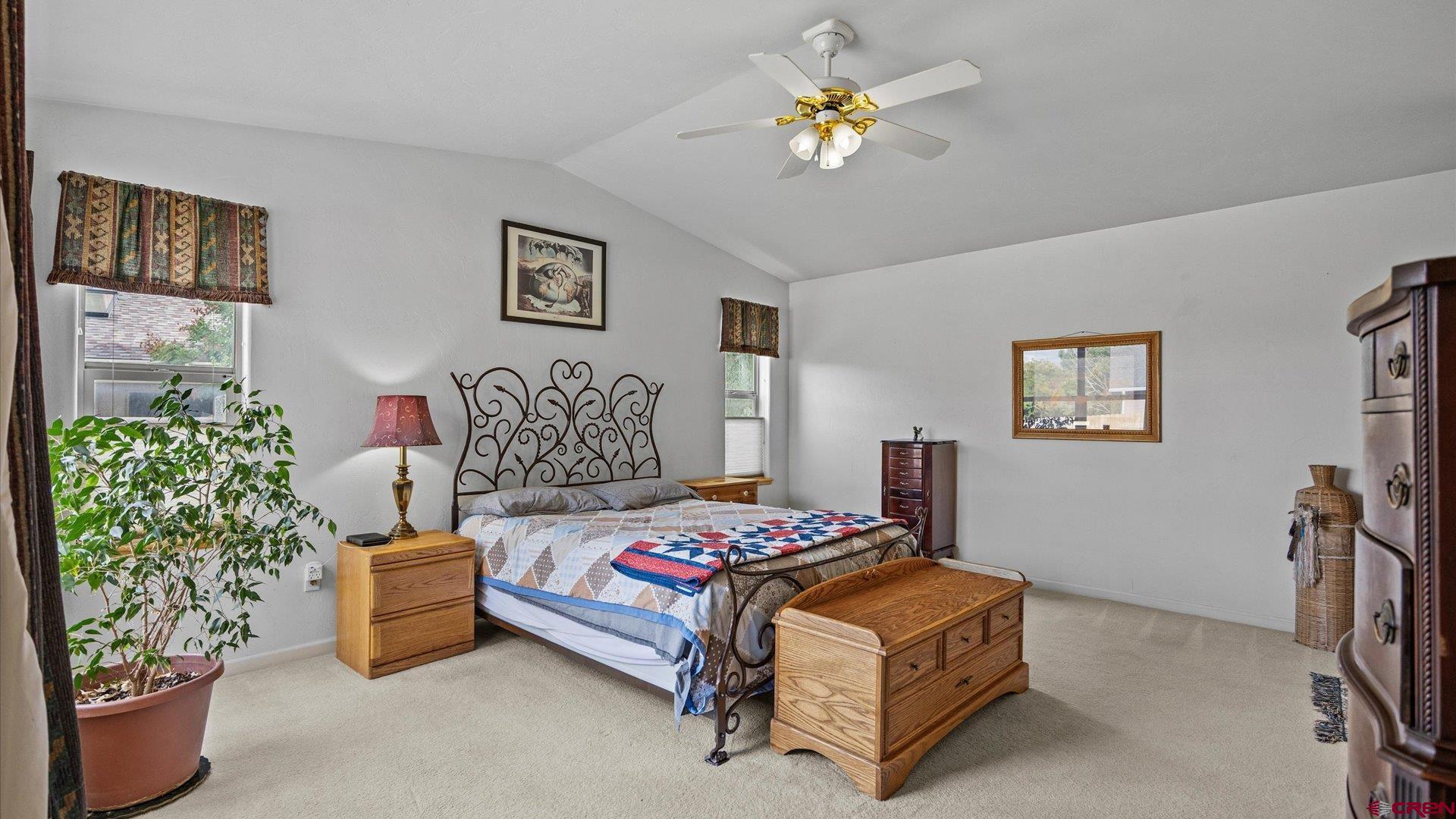 18 Willow Creek Court Parachute, CO 81635 - Photo 19 of 31 a bedroom with a bed and a chandelier