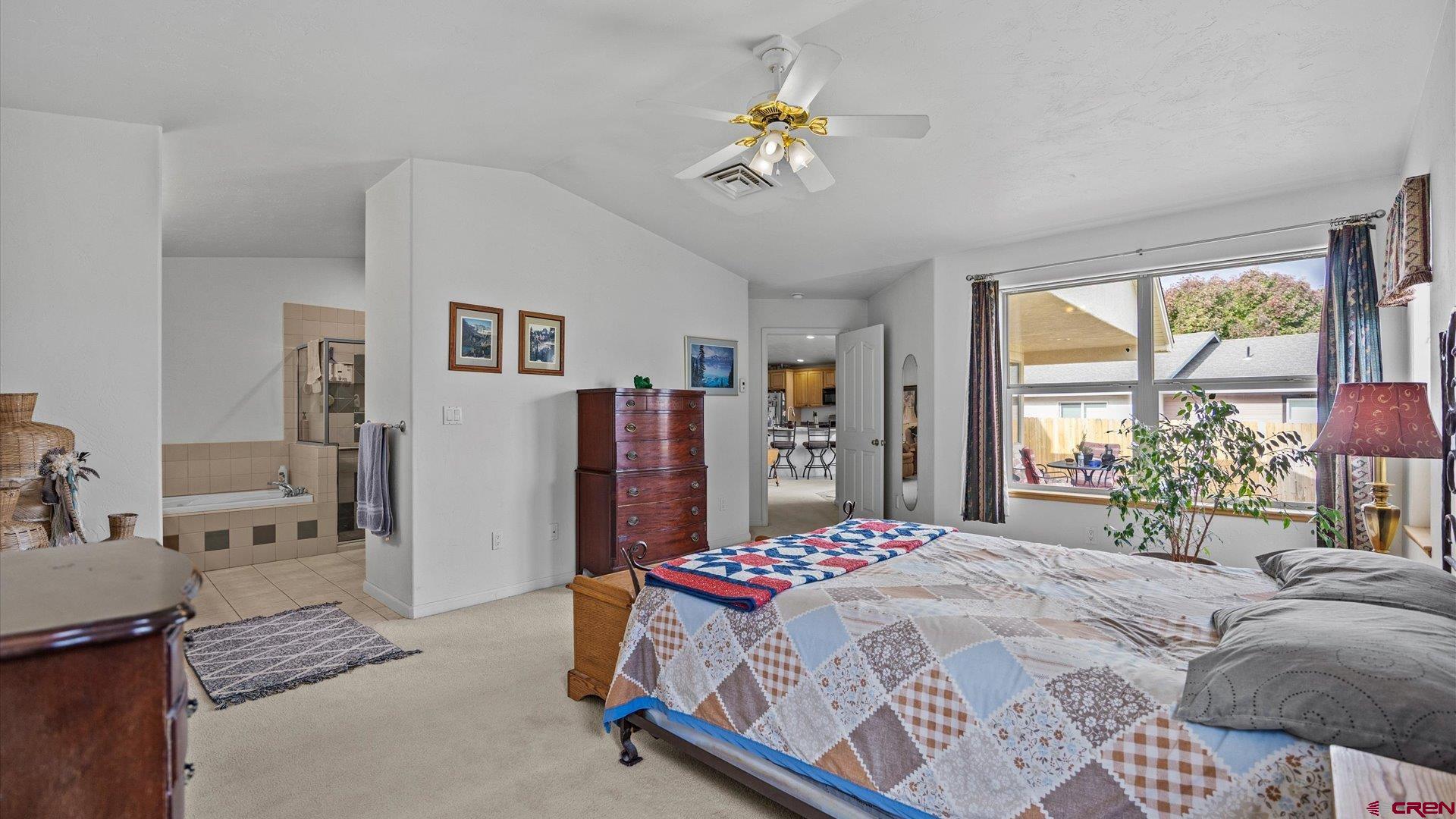 18 Willow Creek Court Parachute, CO 81635 - Photo 20 of 31 a bedroom with a bed and a chandelier