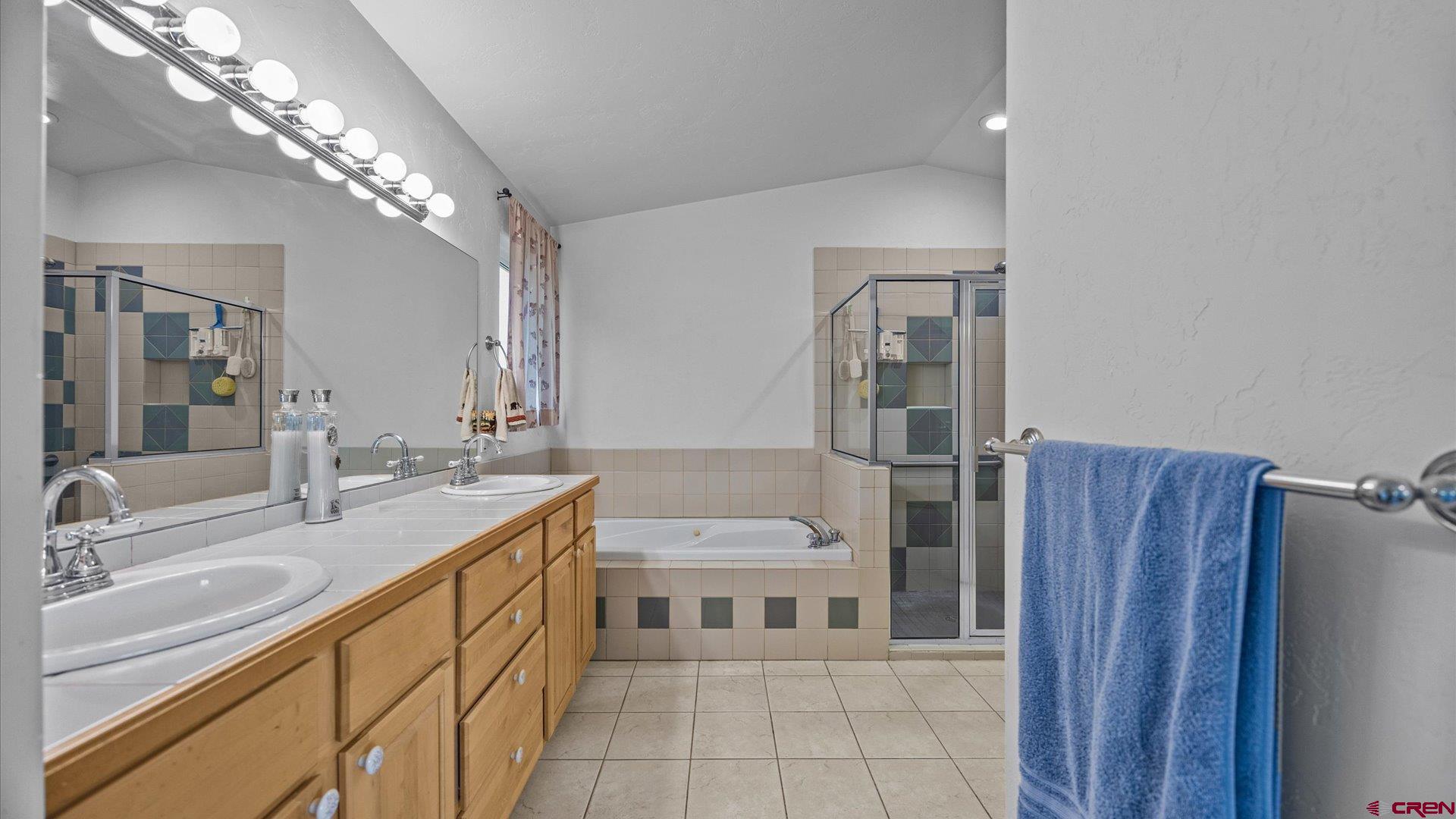 18 Willow Creek Court Parachute, CO 81635 - Photo 21 of 31 a bathroom with a sink a toilet a large mirror and shower