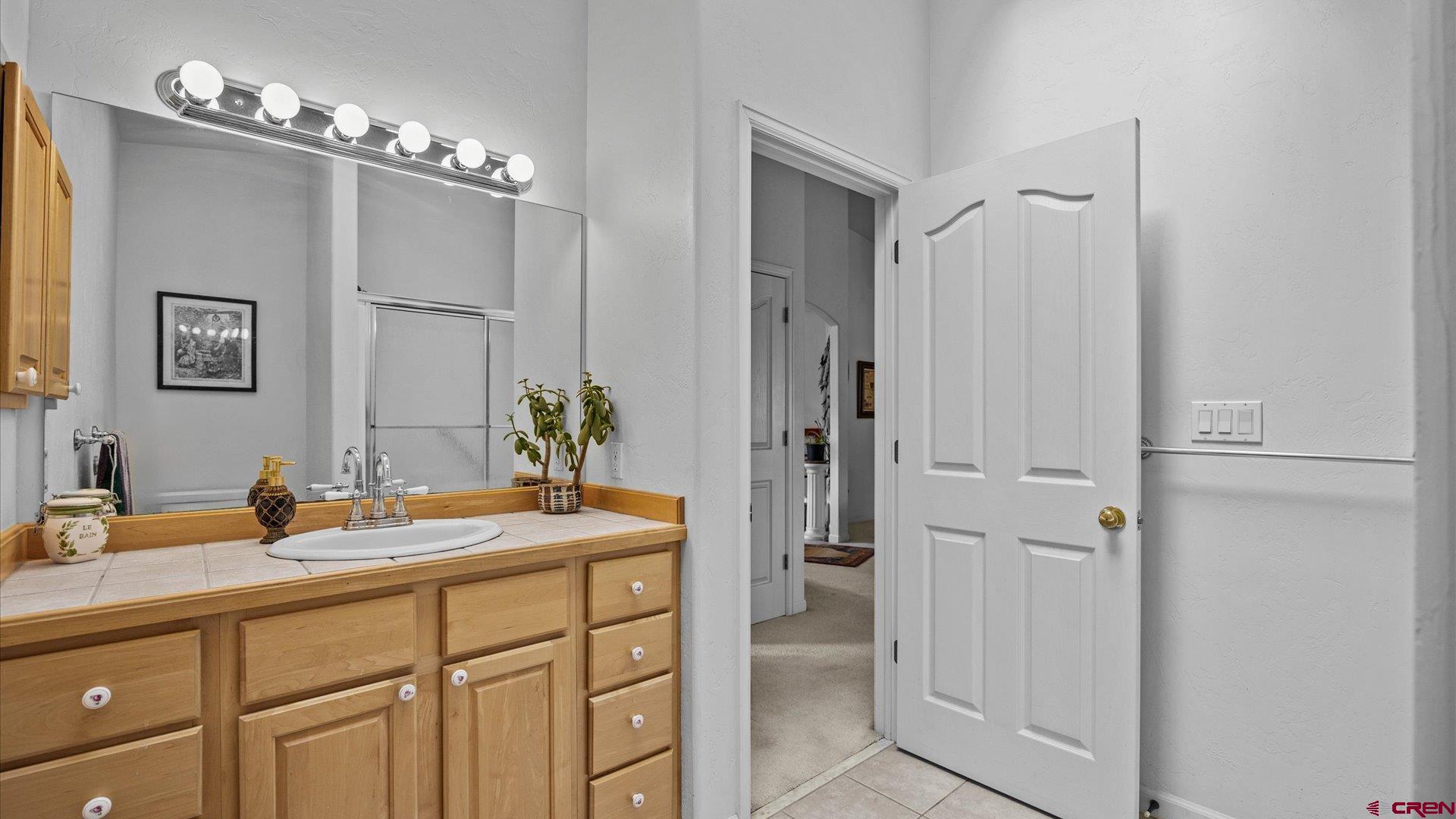 18 Willow Creek Court Parachute, CO 81635 - Photo 25 of 31 a bathroom with a sink vanity and a mirror