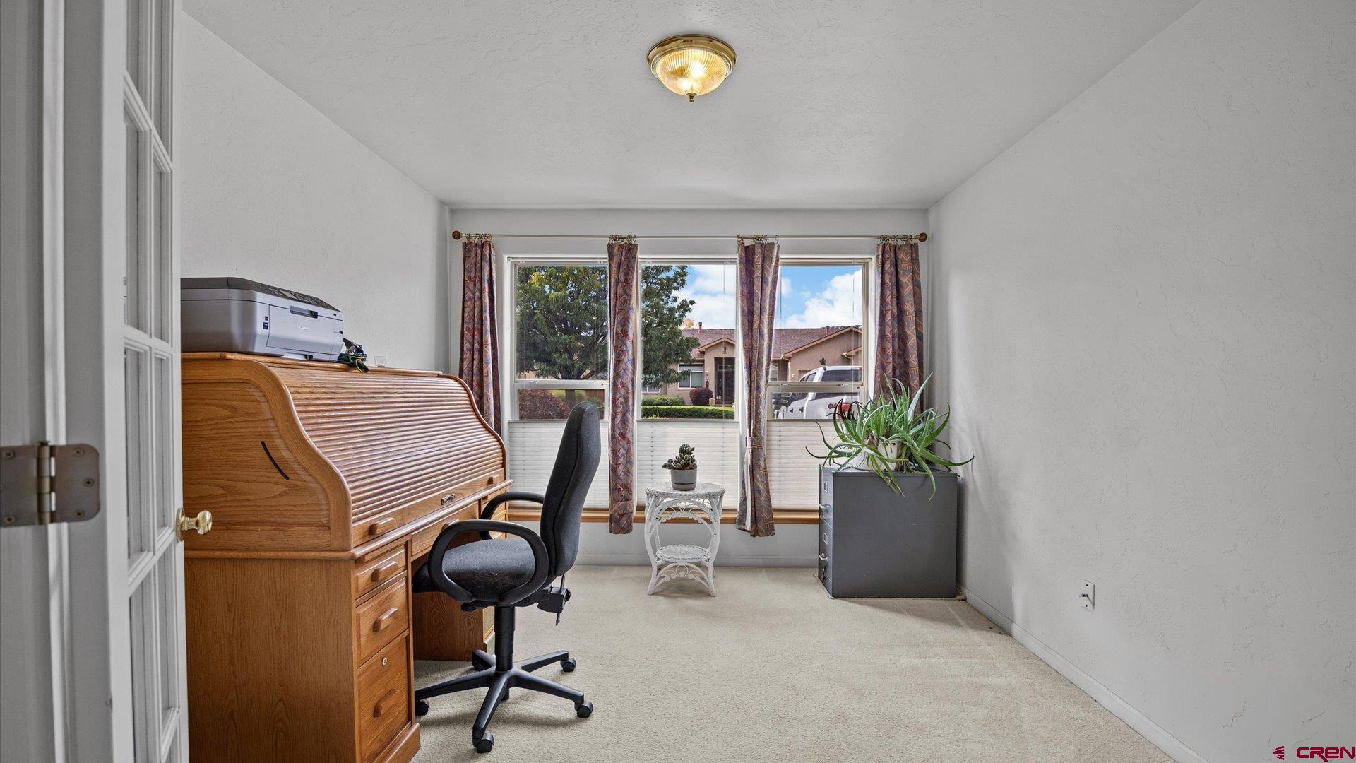 18 Willow Creek Court Parachute, CO 81635 - Photo 27 of 31 a view of a workspace with furniture and a window