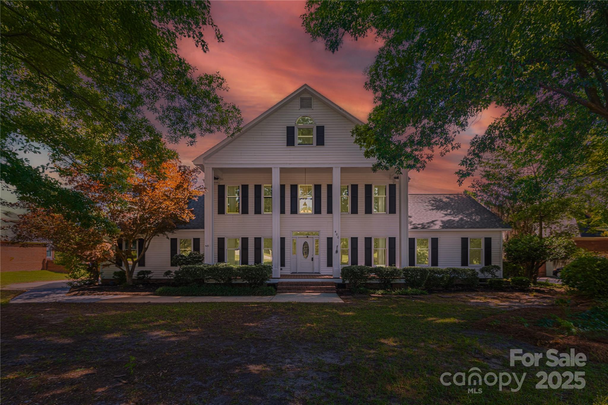 a front view of a house with a garden