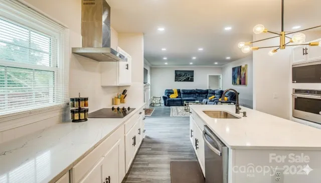 a kitchen with counter top space a sink appliances and cabinets
