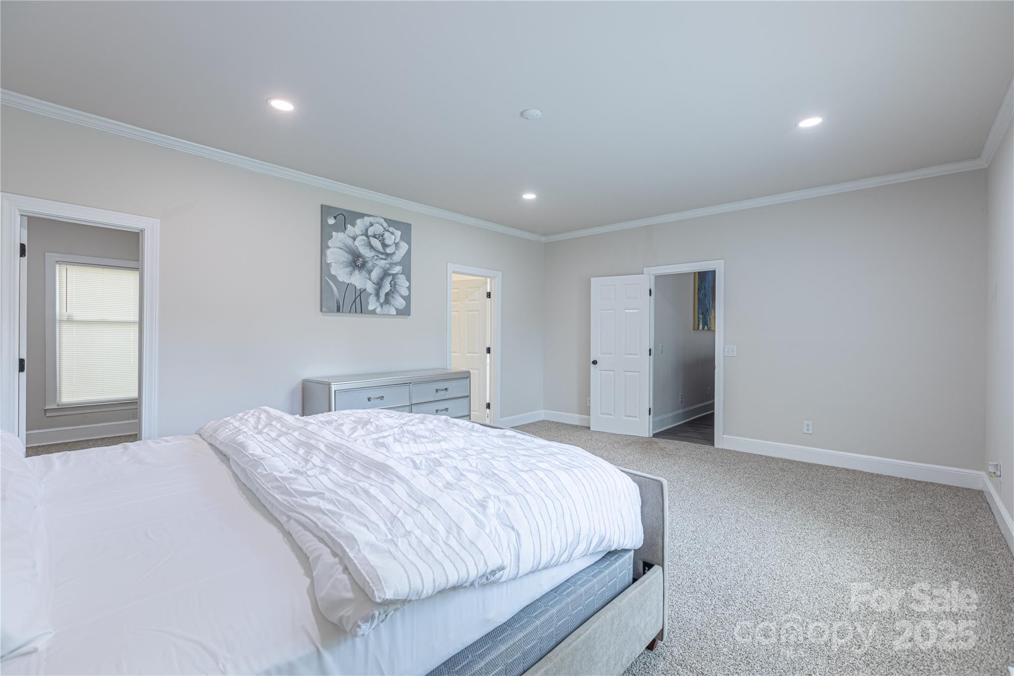 400 Millstone Road Florence, SC 29505 - Photo 18 of 48 a spacious bedroom with a large bed and a painting