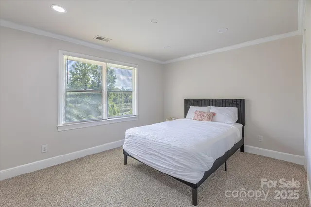 a bedroom with a bed lamp and window