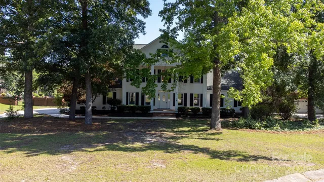 a view of a house with snow on the tree