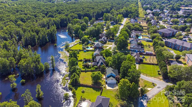 an aerial view of residential house with swimming pool and outdoor space