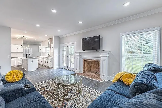 a living room with furniture fireplace and a flat screen tv