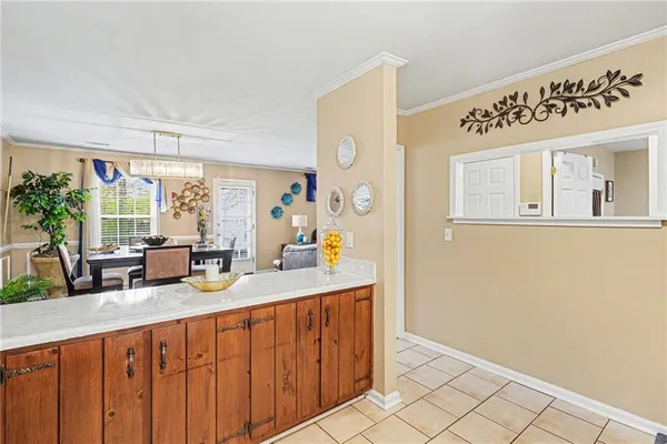 a kitchen with sink cabinets and living room view