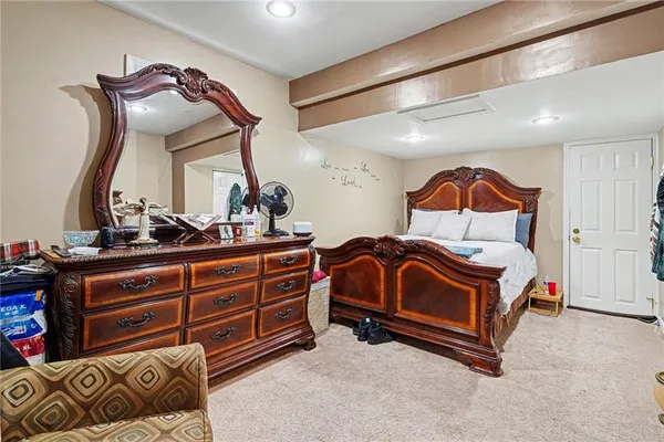 a bedroom with a bed and a mirror