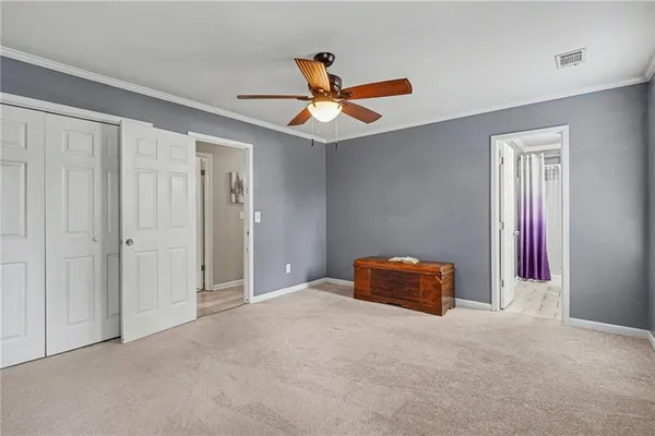 a furnished livingroom with a ceiling fan and a window