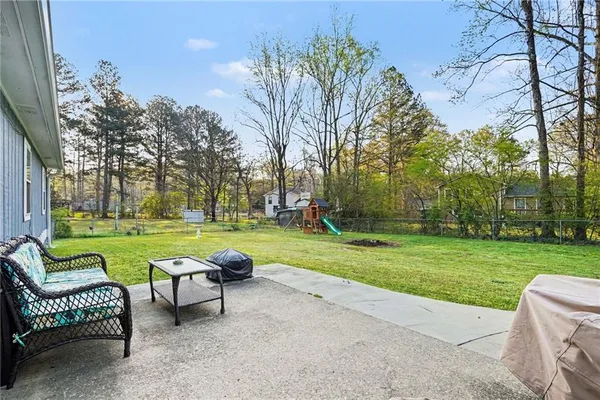 a view of a swimming pool and couches in the patio