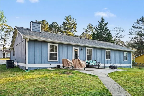 a front view of house with yard patio and outdoor seating