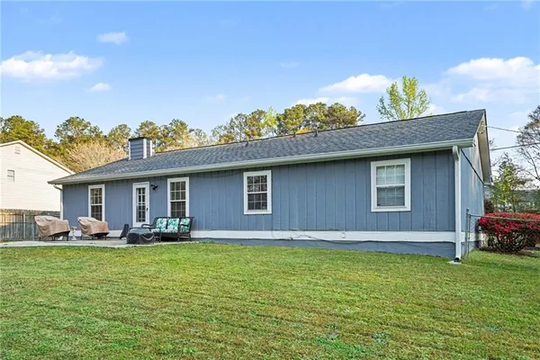 a front view of house with yard outdoor seating and green space