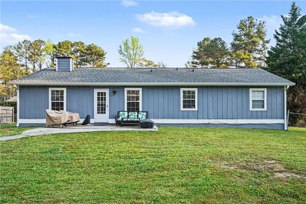 a house view with a sitting space and garden