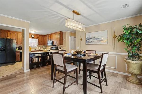 a view of a dining room with furniture and a kitchen