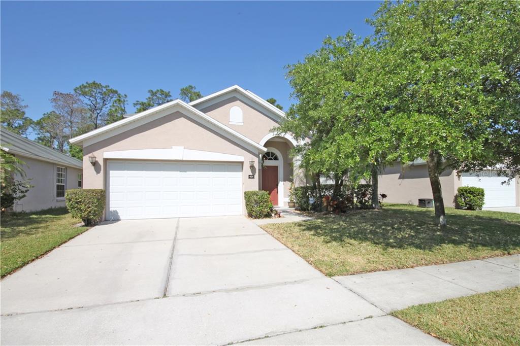 4011 Andover Cay Boulevard Orlando, FL 32825 - Photo 1 of 1 a front view of a house with a yard and garage