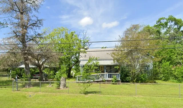 a view of a large building with a big yard and large trees