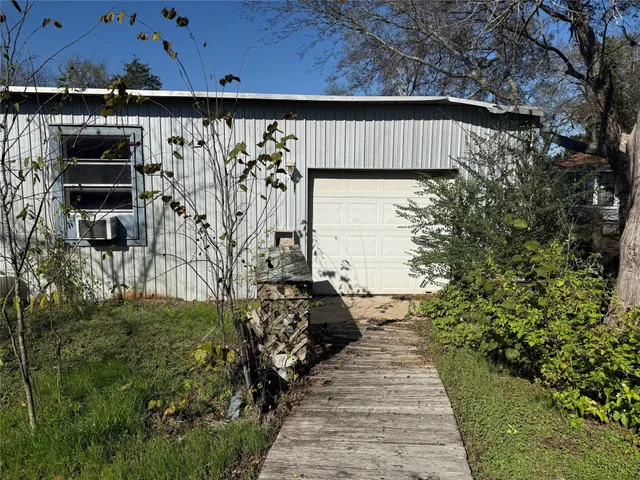 a view of a pathway of a building with wooden fence