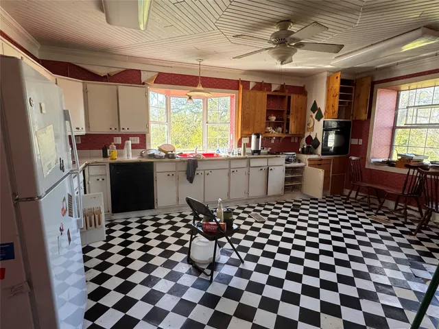 a kitchen with a sink a stove a refrigerator and cabinets