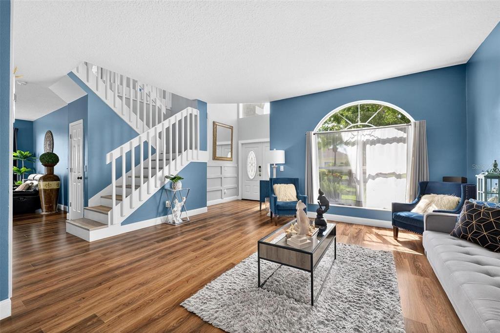 413 Rockafellow Way Orlando, FL 32828 - Photo 13 of 88 a living room with furniture and a large window with wooden floor