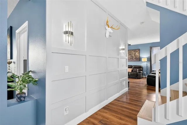 a dining room with furniture water view and a floor to ceiling window