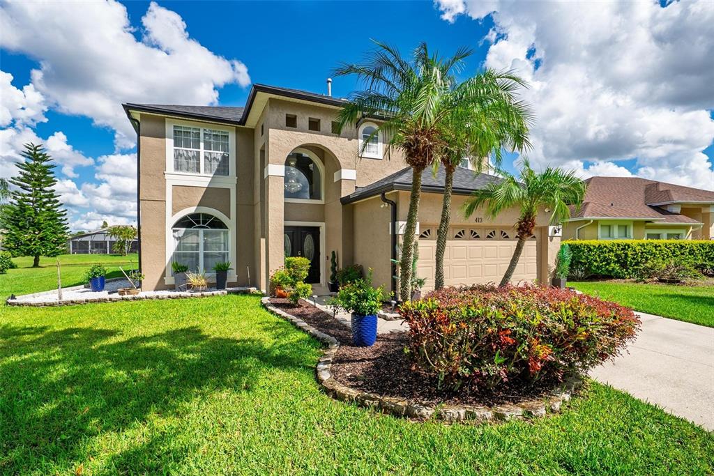 413 Rockafellow Way Orlando, FL 32828 - Photo 2 of 88 a front view of a house with a yard