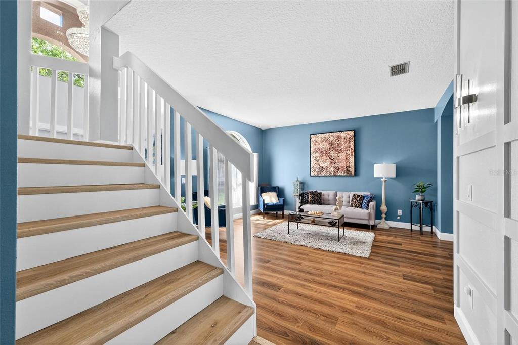 413 Rockafellow Way Orlando, FL 32828 - Photo 21 of 88 a living room with wooden floor and a chandelier