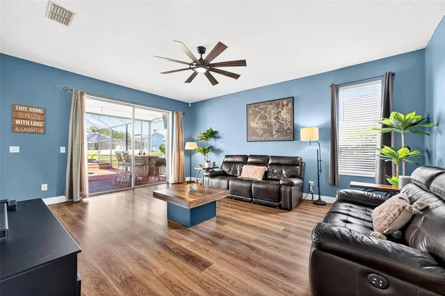 a kitchen with stainless steel appliances granite countertop a stove top oven a sink dishwasher and a refrigerator with wooden cabinets