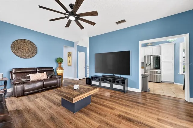 a view of a hallway view with wooden floor and staircase