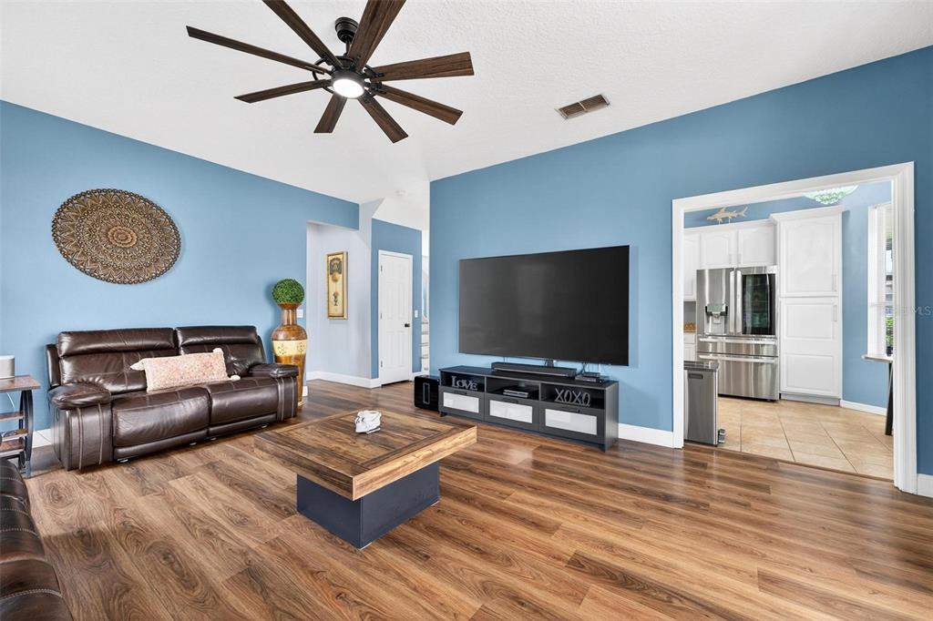 413 Rockafellow Way Orlando, FL 32828 - Photo 27 of 88 a living room with furniture and a flat screen tv