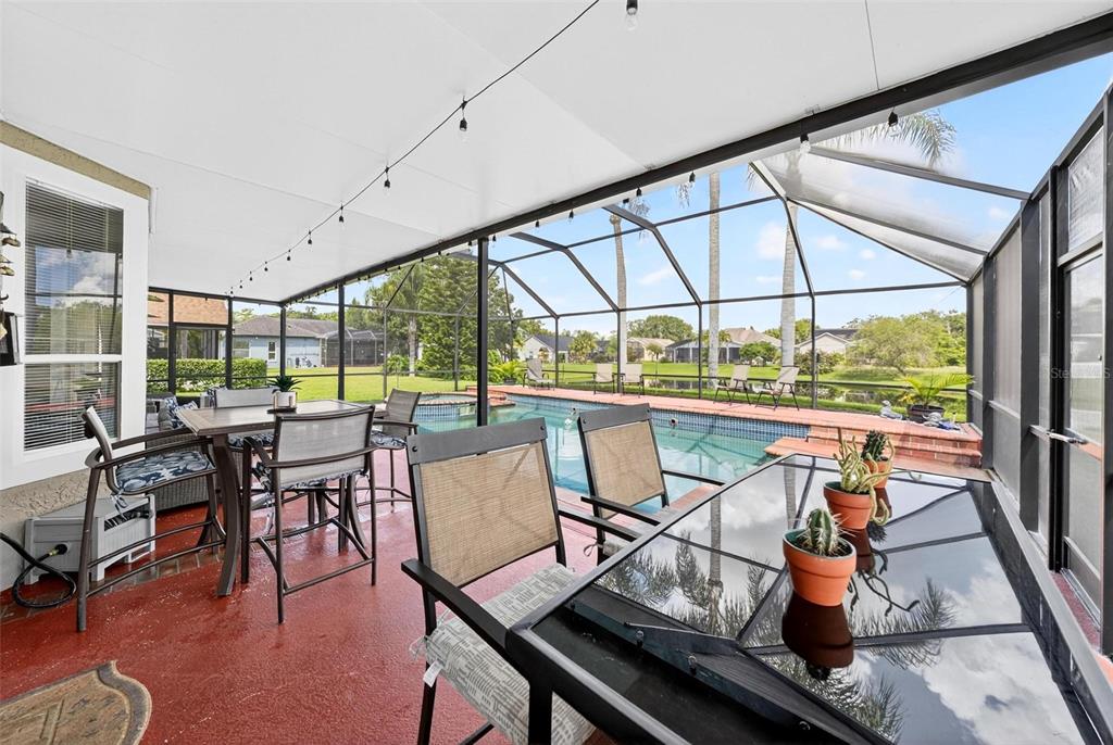 413 Rockafellow Way Orlando, FL 32828 - Photo 29 of 88 a dining room with furniture water view and a floor to ceiling window