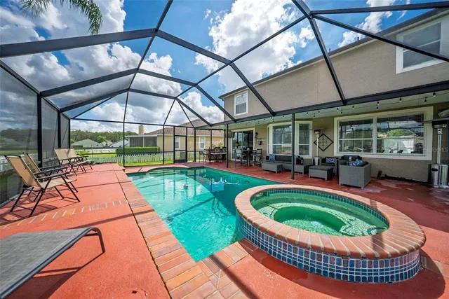 a bathroom with a white tub shower sink and mirror