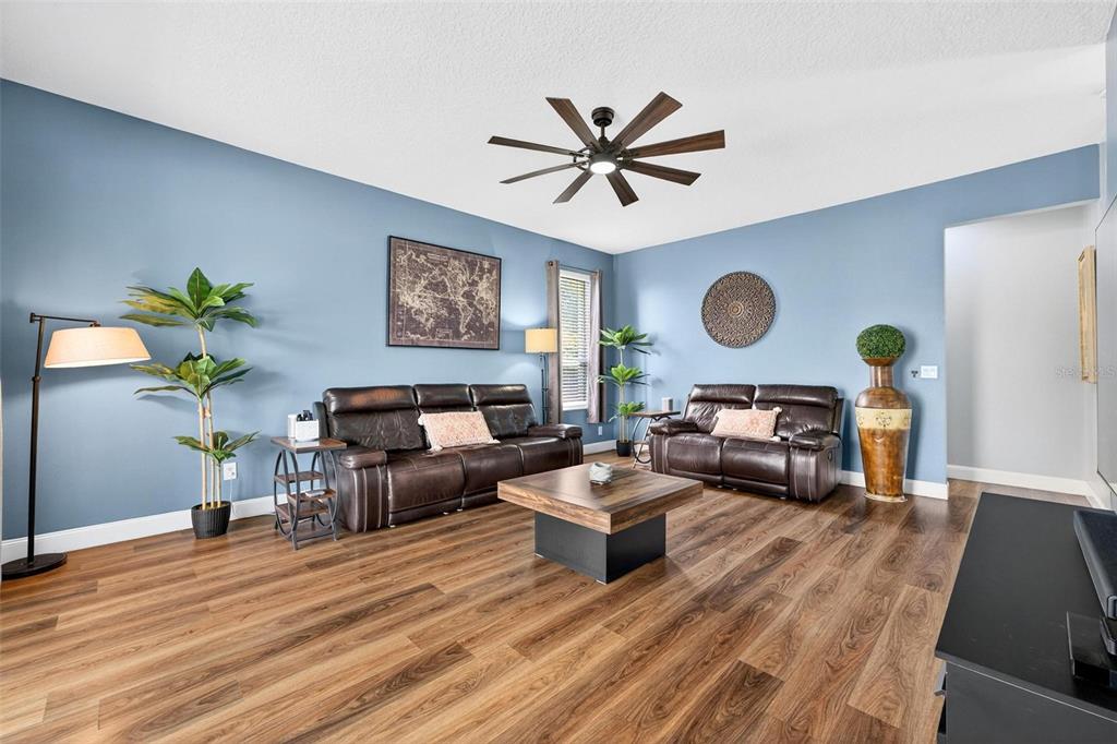 413 Rockafellow Way Orlando, FL 32828 - Photo 37 of 88 a living room with furniture and a wooden floor