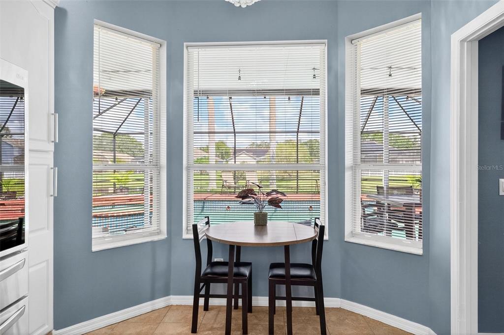 413 Rockafellow Way Orlando, FL 32828 - Photo 43 of 88 a dining room with wooden floor and a table