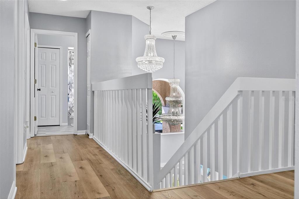 413 Rockafellow Way Orlando, FL 32828 - Photo 48 of 88 a view of a hallway view with wooden floor and staircase