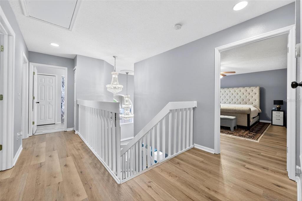 413 Rockafellow Way Orlando, FL 32828 - Photo 50 of 88 a view of a hallway with wooden floor and furniture