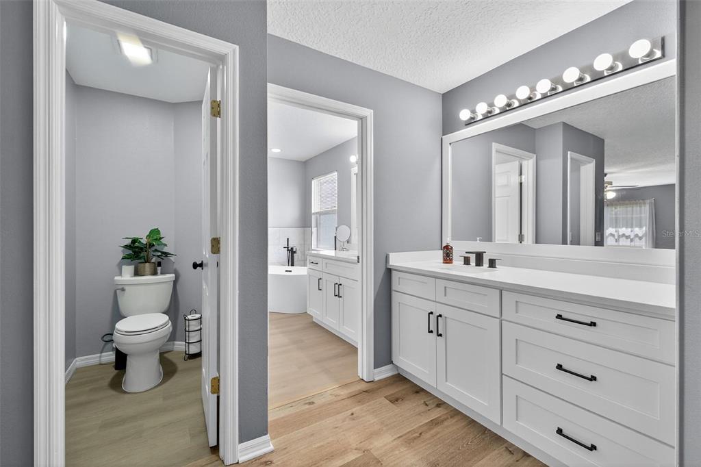 413 Rockafellow Way Orlando, FL 32828 - Photo 59 of 88 a spacious bathroom with a double vanity sink toilet and a mirror