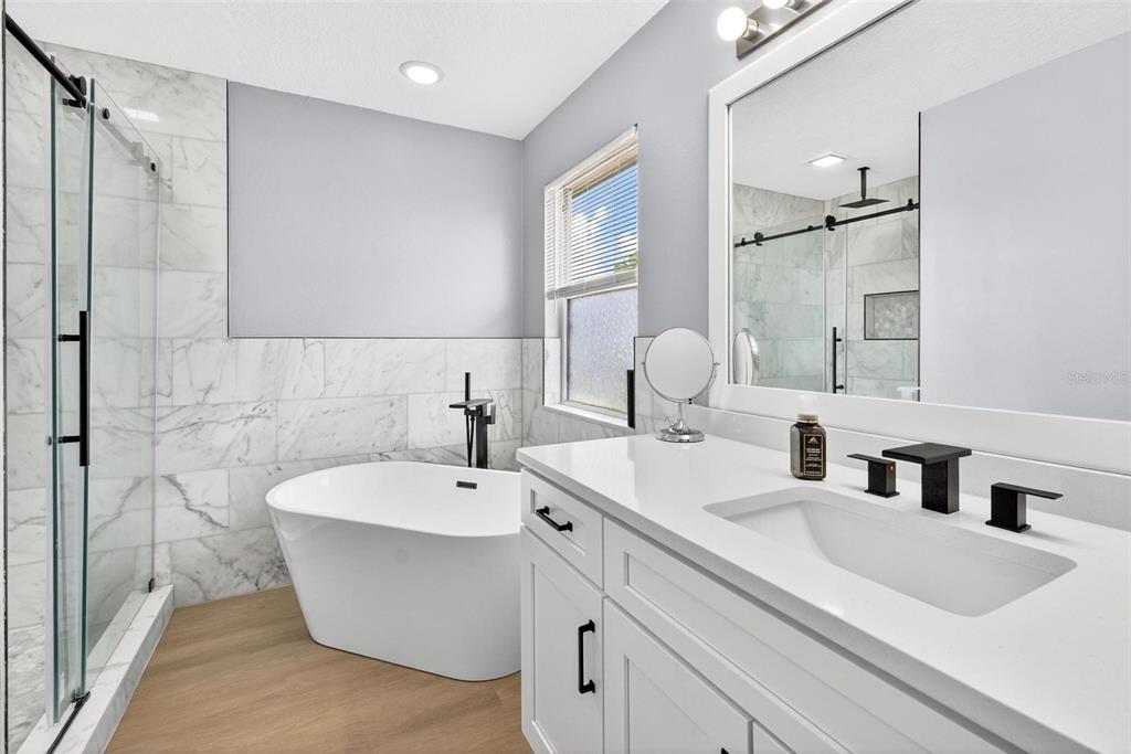 413 Rockafellow Way Orlando, FL 32828 - Photo 60 of 88 a bathroom with a white tub shower sink and mirror