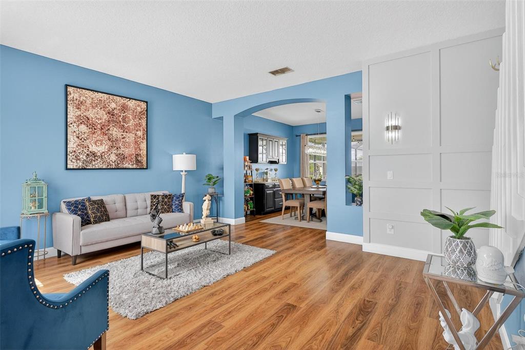 413 Rockafellow Way Orlando, FL 32828 - Photo 6 of 88 a living room with furniture and wooden floor