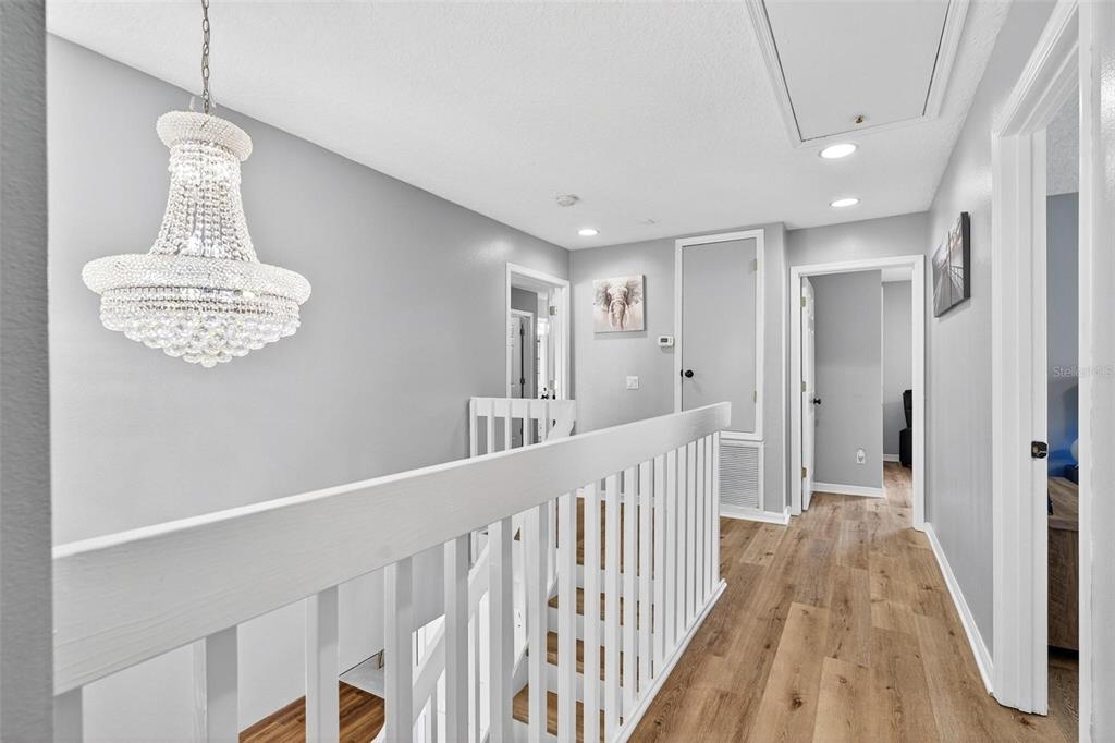 413 Rockafellow Way Orlando, FL 32828 - Photo 73 of 88 a view of a hallway with wooden floor and staircase
