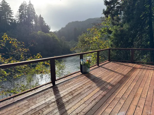 a view of balcony with wooden floor and fence