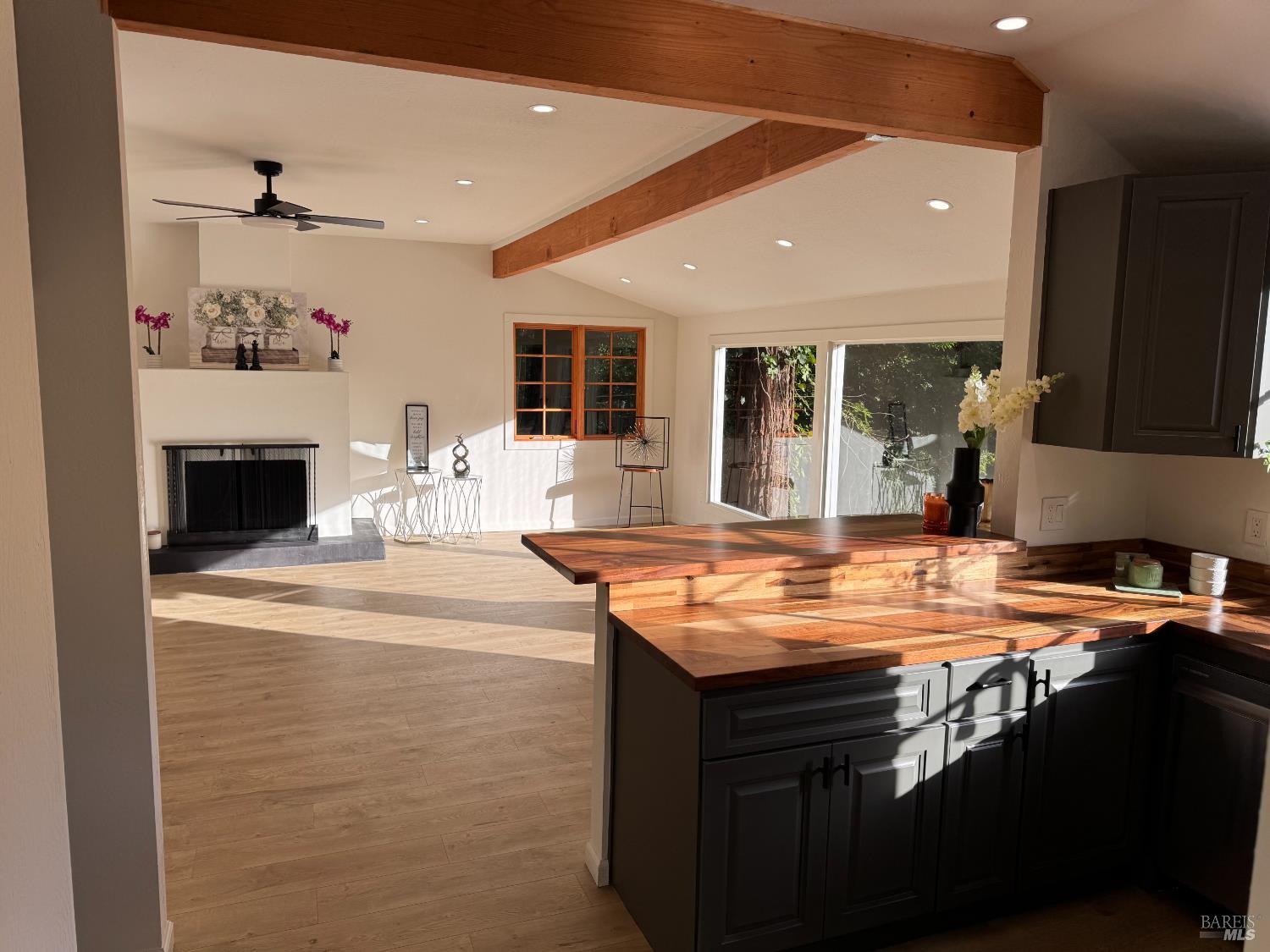 21883 Highway 116 Monte Rio, CA 95462 - Photo 11 of 28 a room with kitchen island a sink and a stove with wooden floor