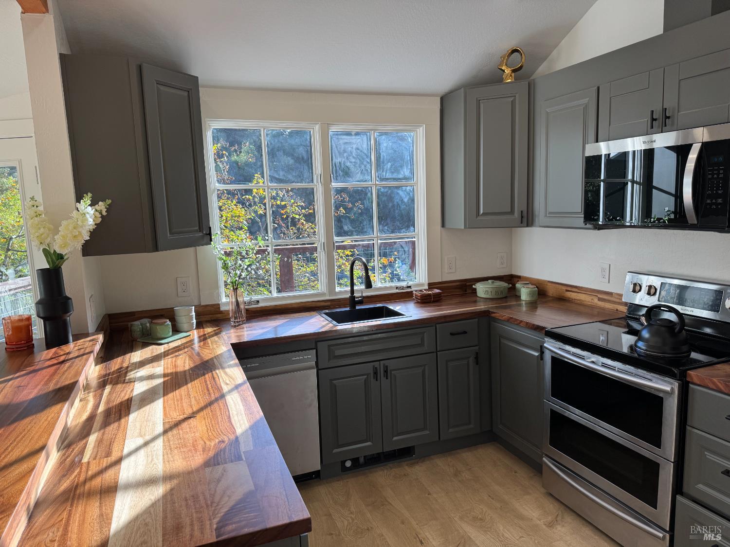 21883 Highway 116 Monte Rio, CA 95462 - Photo 12 of 28 a kitchen with stainless steel appliances kitchen island granite countertop a sink stove and cabinets