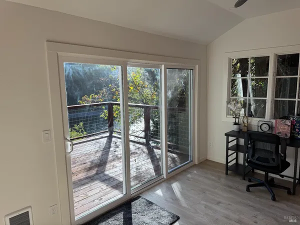 a view of a room with a table and chairs